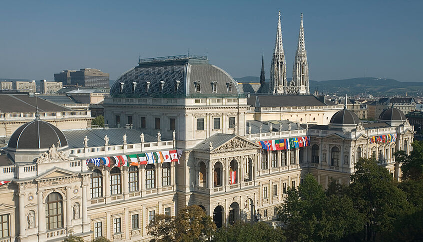 front view of the Main Building with several different flags