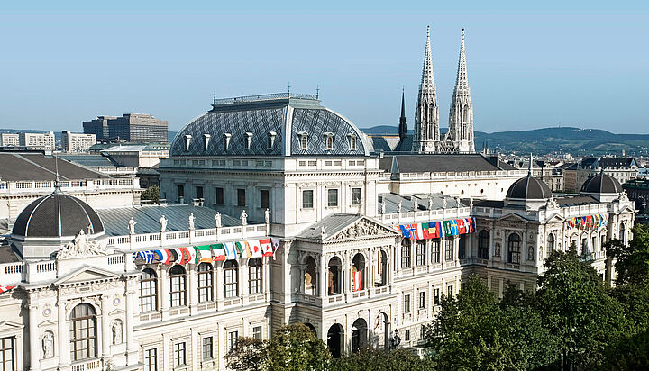 front view of the Main Building with several different flags